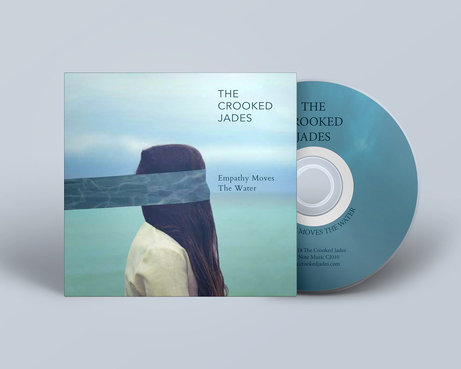 cover artwork of album titled Empathy Moves the Water with the CD on the right
