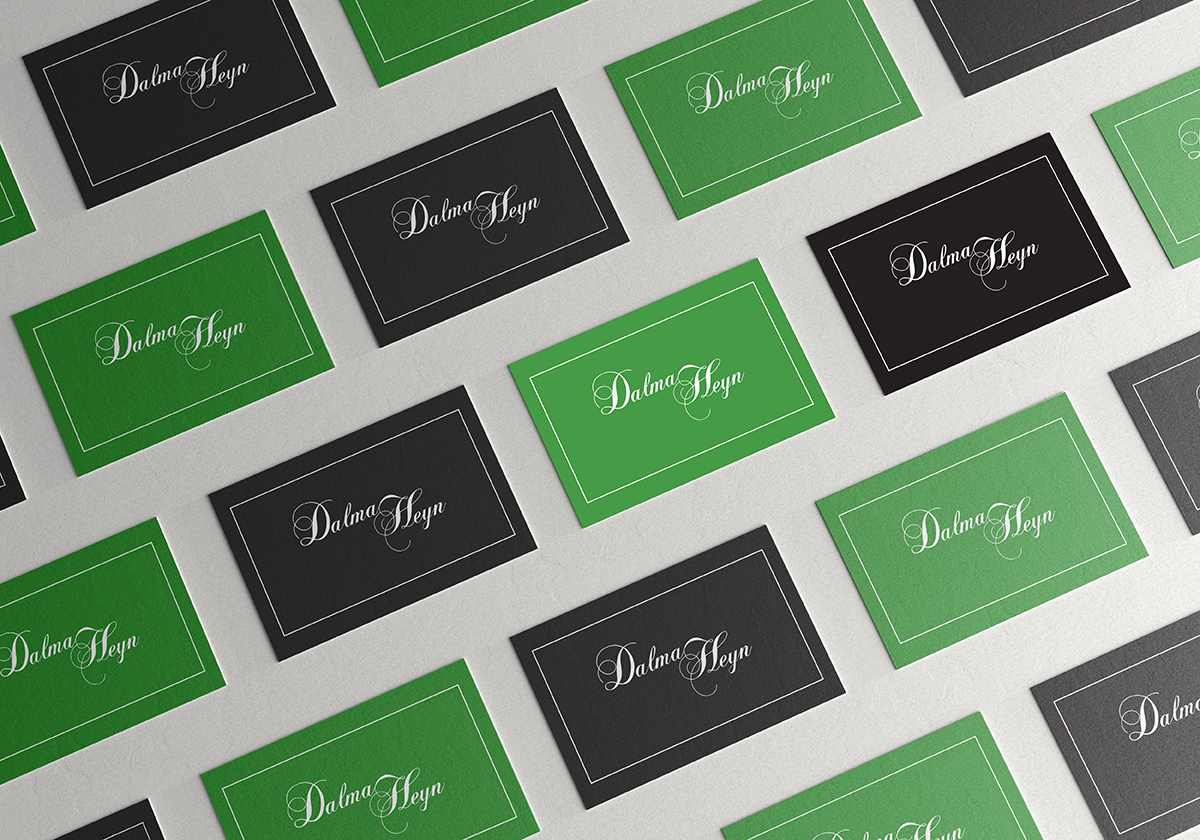 alternating arrangement of black and green business cards on a white background