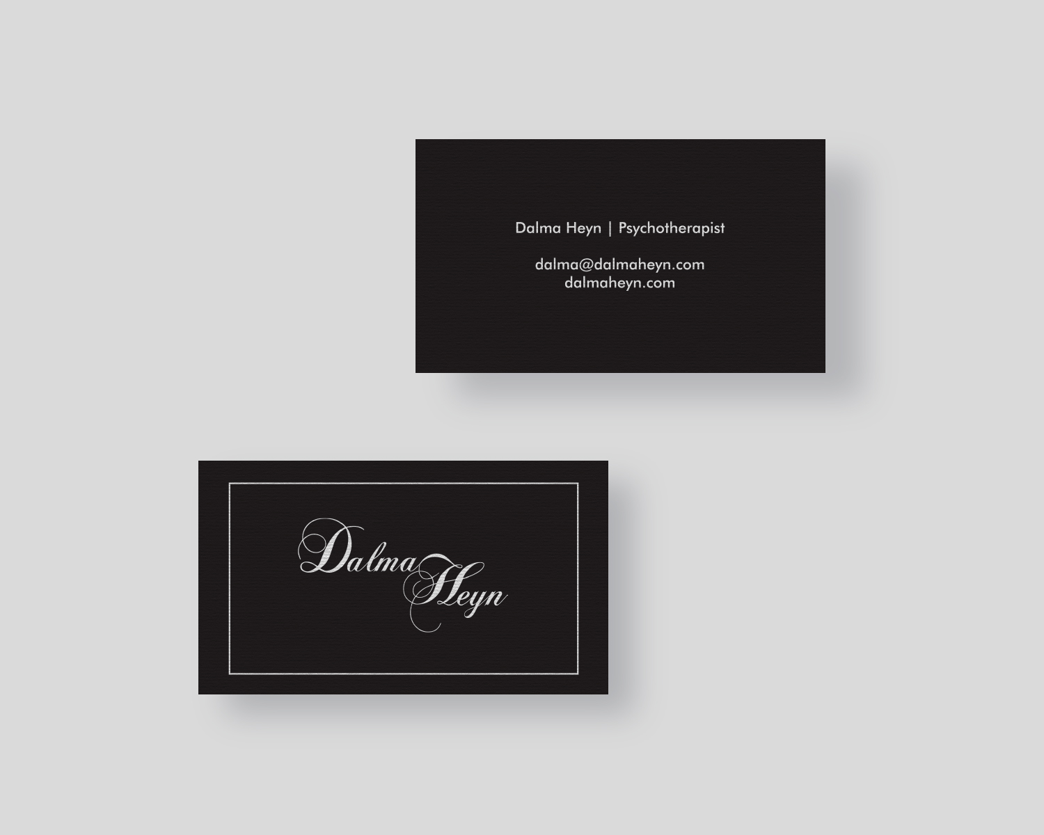front and back of a business card on a black background